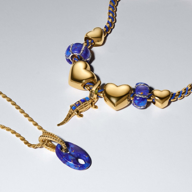 A selection of blue and 14k gold-plated bracelets and charms.