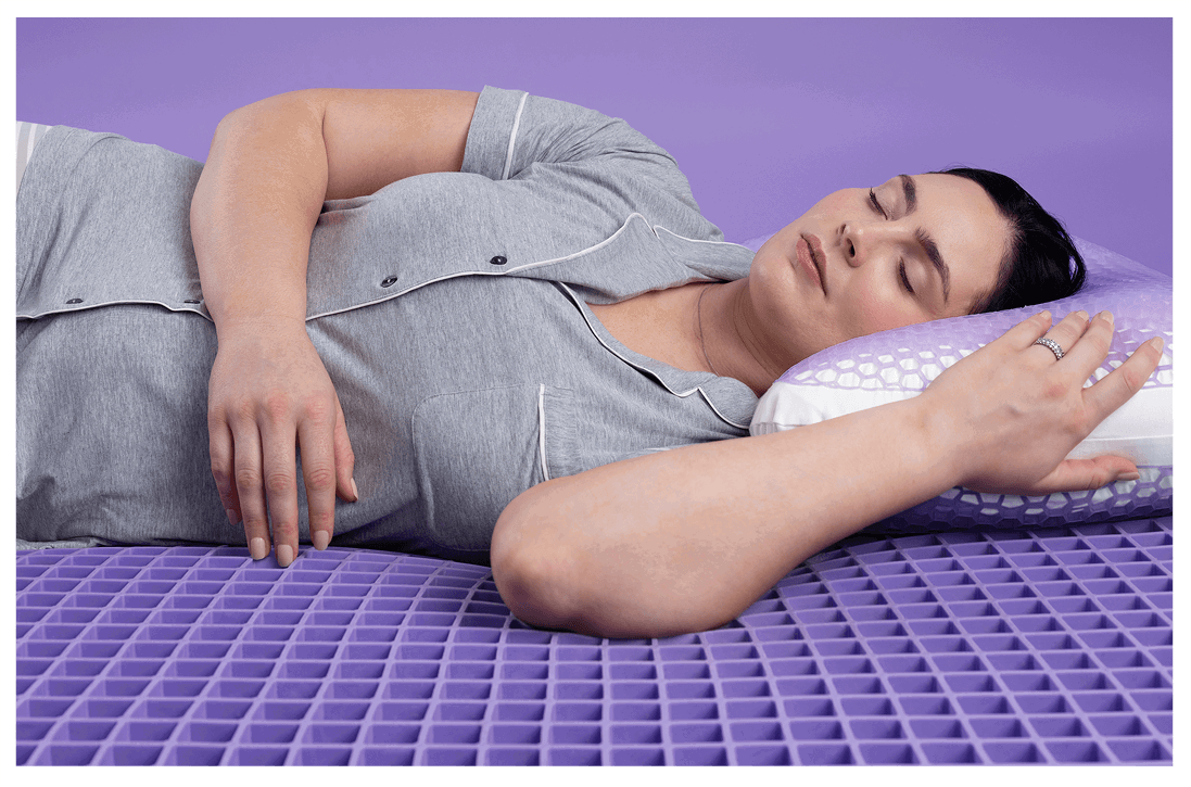 Woman sleeping on purple pillow and mattress