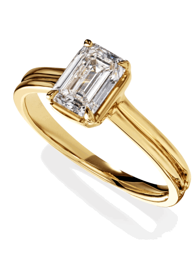 An emerald-cut diamond solitaire ring in a yellow gold four-prong setting.