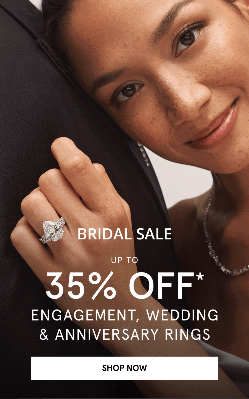 A couple showcasing a diamond ring. Up to 35% off engagement, wedding and anniversary rings. Click shop now.