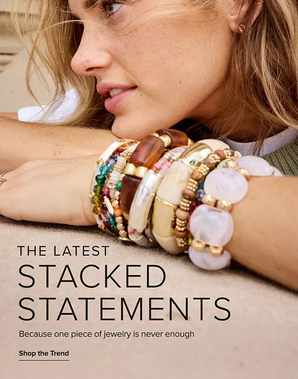 The latest. Stacked statements. Because one piece of jewelry is never enough. Shop the trend. A woman wearing a bunch of different bracelets.