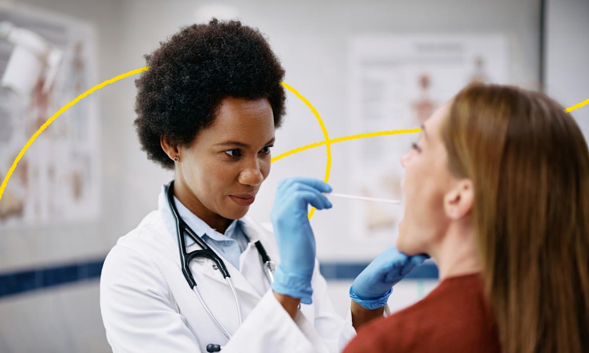 female doctor inspecting woman's mouth