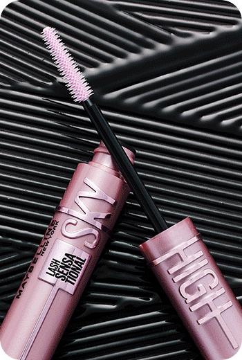 Lifestyle image of an open Sky High Mascara tube displaying the brush with a black line textured background of formula.