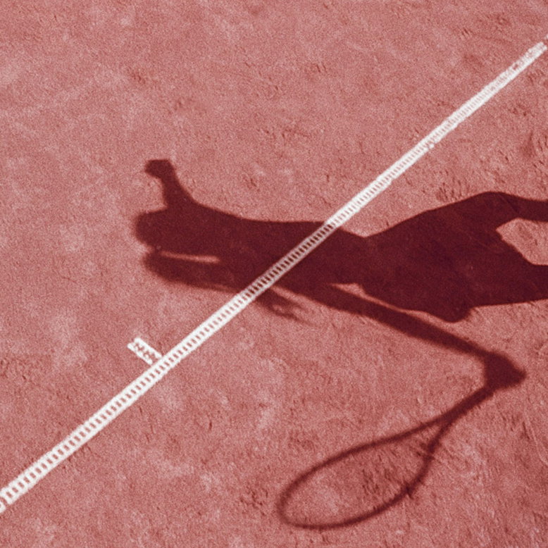 A shadow of tennis player on a pink court.