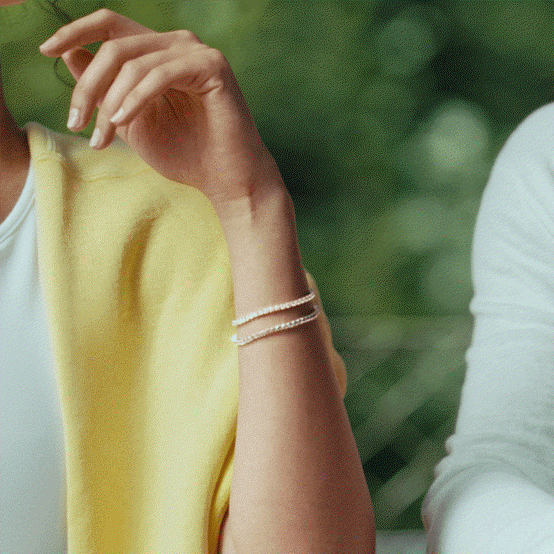 Two models pose with Pandora tennis bracelets.