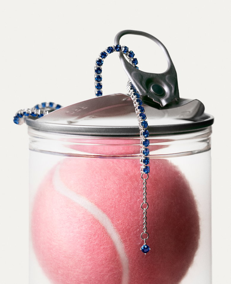 Close-up Pandora tennis bracelet on a pink tennis ball.