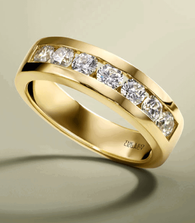 A yellow gold wedding band with channel-set round diamonds.