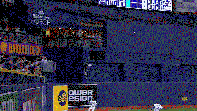 An animated gif of Cedric Mullins making a catch before crashing into the wall and losing his cap