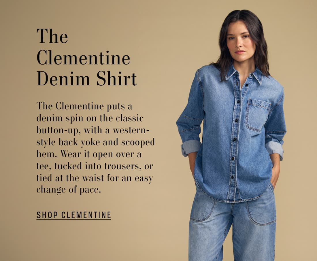 Image of model wearing Clementine in Indigo. Text reads: The Clementine Denim Shirt. The Clementine puts a denim spin on the classic button-up, with a western-style back yoke and scooped hem. Wear it open over a tee, tucked into trousers, or tied at the waist for an easy change of pace.