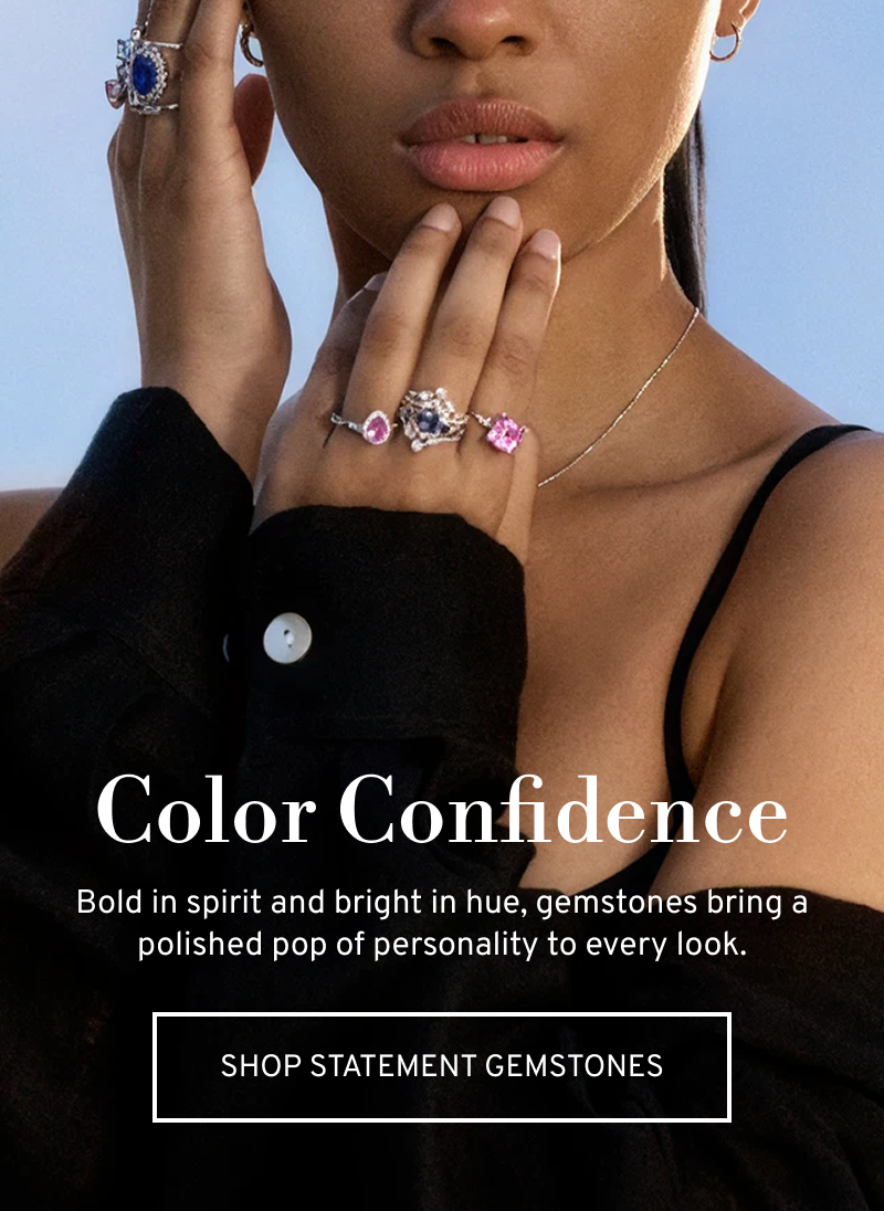 A model wearing several gemstone cocktail rings. Add a pop of personality to every look. Click to Shop Statement Gemstones