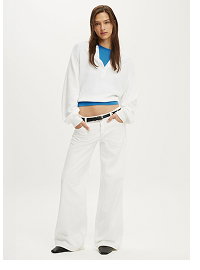 Woman wearing white long-sleeve shirt and white wide-leg pants