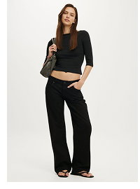 Woman wearing black crop top and black wide-leg pants