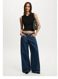 Woman wearing black sleeveless tank top and dark blue wide-leg jeans