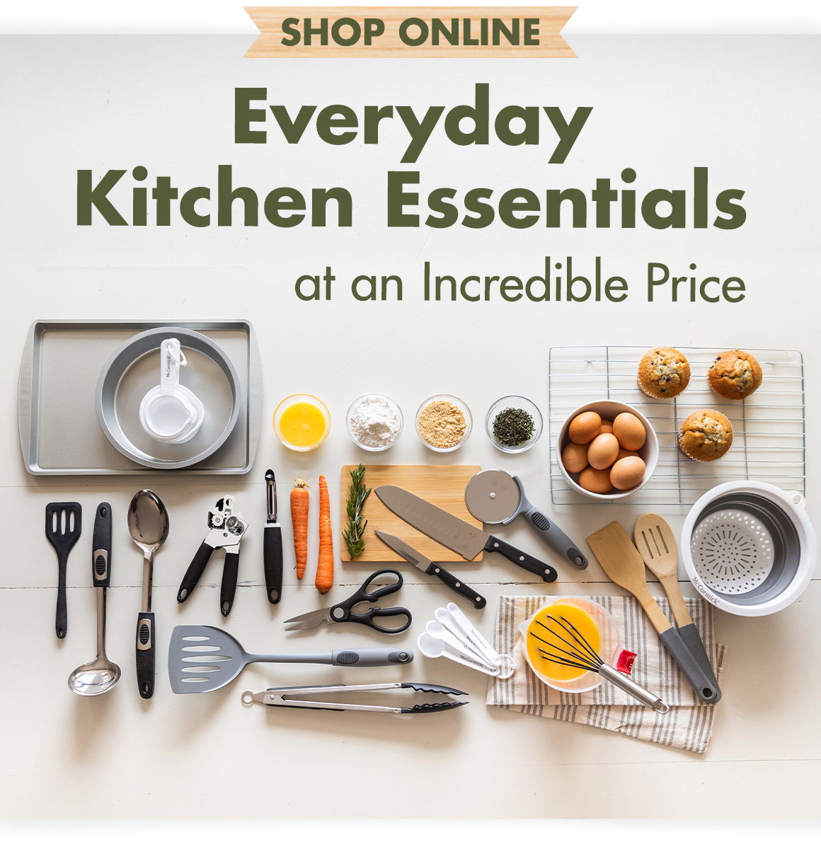 Everyday Kitchen Essentials at an Incredible Price. Image of kitchen tools arreanged on a surface: turners, spatulas, ladles, tongs, measuting spoons and cups, knives, cutting boards, whisks, kitchen towels, small prep bowls, a colander, a can opener, vegetable peeler, and baking pans.