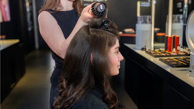 Customer gets their hair dried and styled in a Dyson Store Beauty Lab.