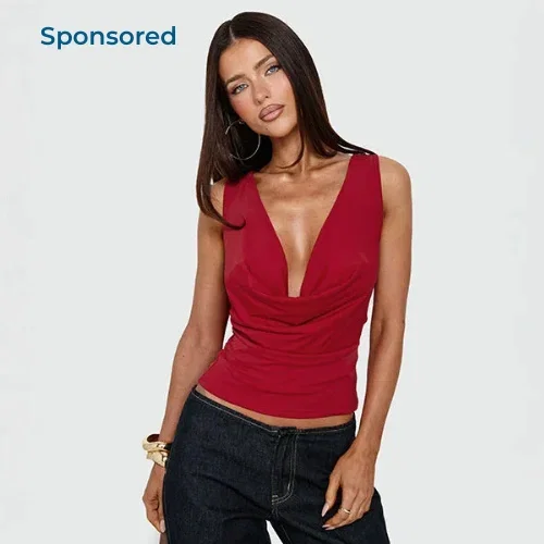 woman wears red tank and black jeans