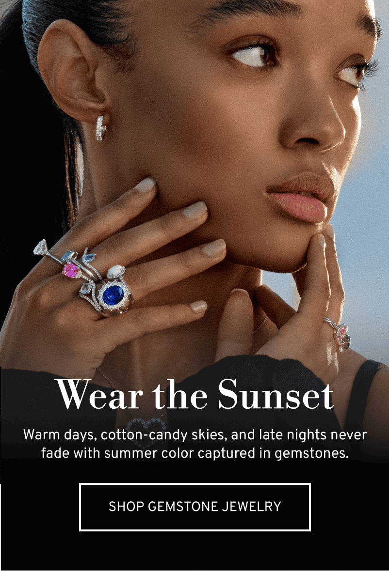A model in the sun wearing several gemstone cocktail rings. Wear the sunset. Click to Shop Gemstone Jewelry