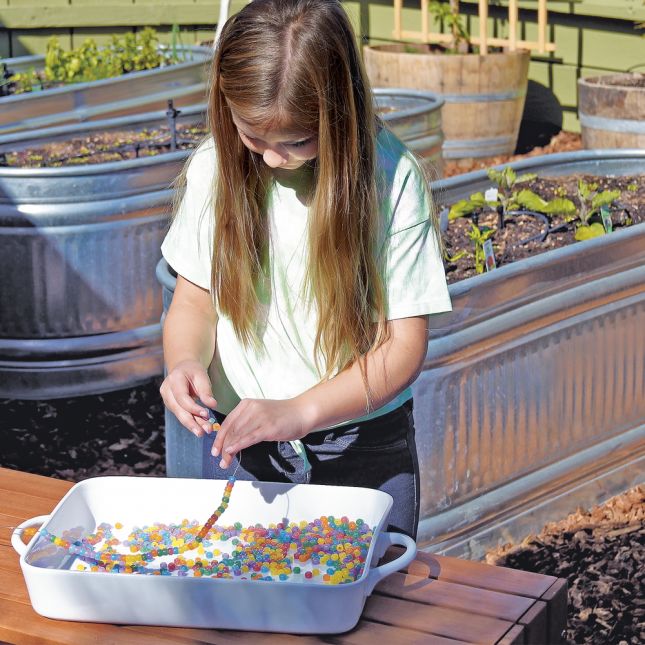 Student interacting with UV Color Changing Beads