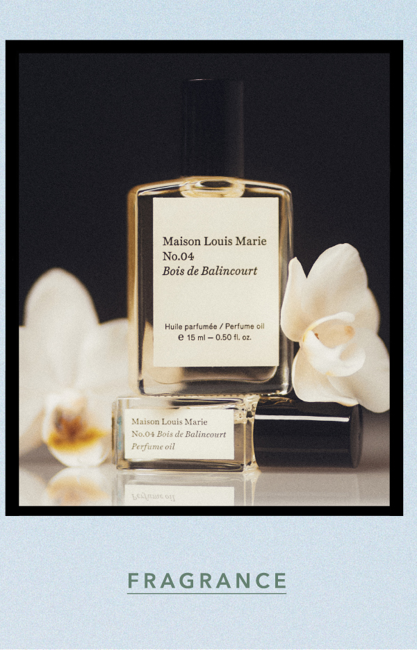 Maison Louis Marie No.04 Bois de Balincourt perfume oil bottle stacked on a glass vial with white orchid blossoms on a dark background. Text: FRAGRANCE.
