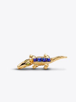A gold and blue crocodile charm