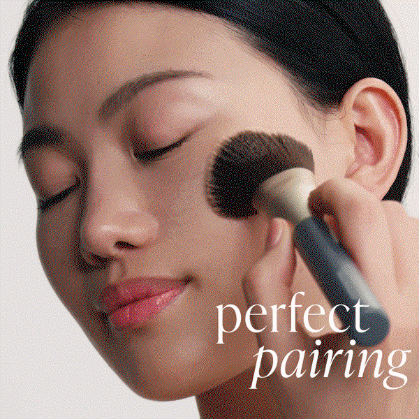 image of model applying Glow Fixation with brush 