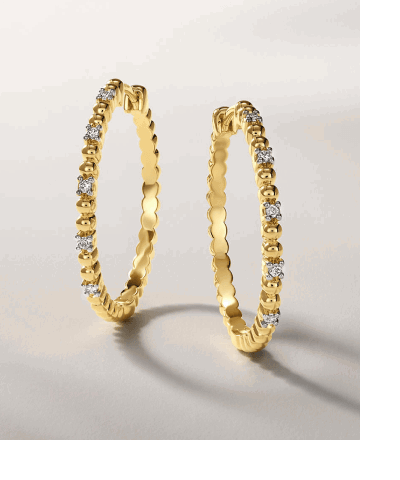Yellow gold hoop earrings with diamond accents.