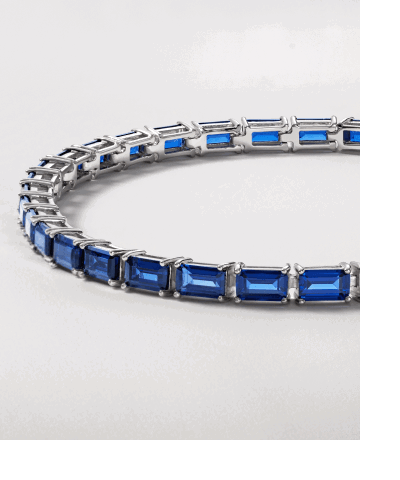 Blue sapphire tennis bracelet in a silver-tone setting.
