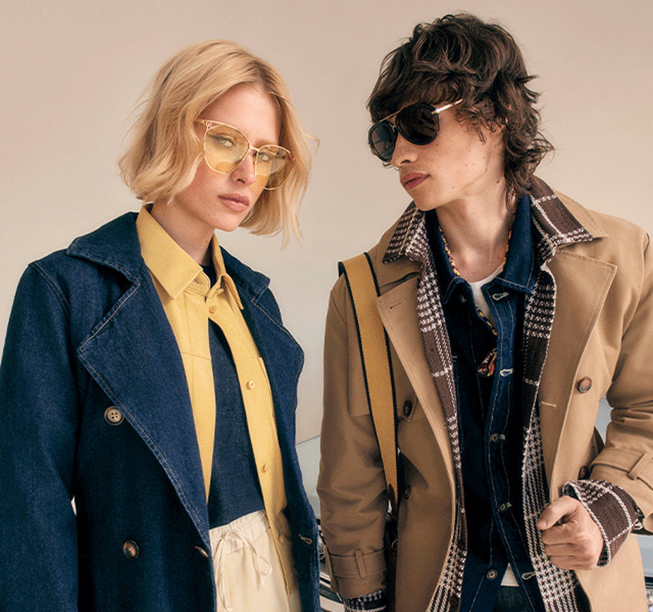 Two models wearing denim and neutral-toned jackets with sunglasses.