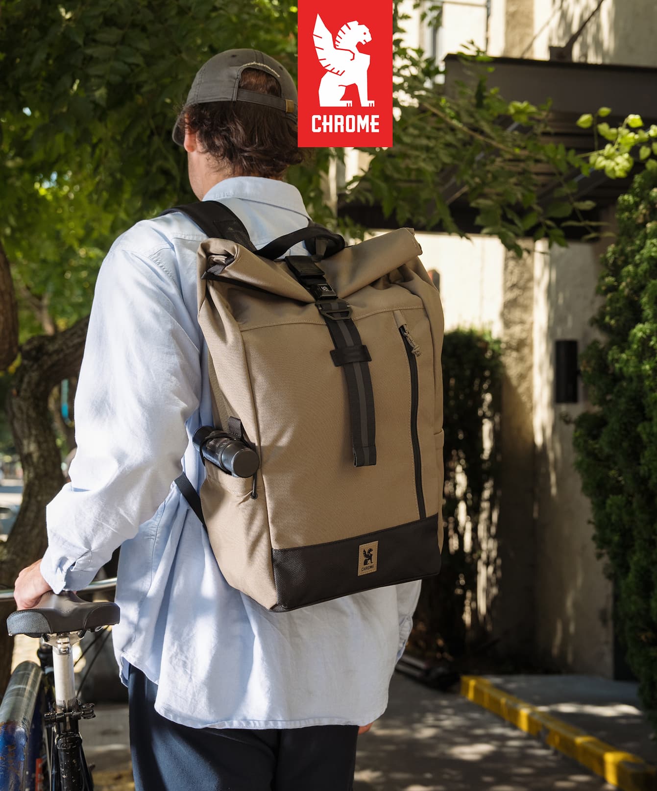 A man walking a bike wearing a new Initiate 26L Pack