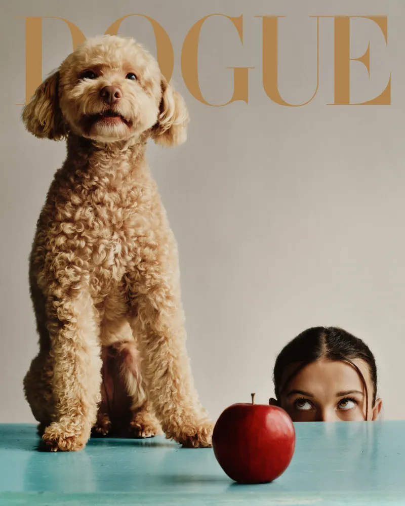 Image may contain: Millie Bobby Brown, Adult, Person, Animal, Canine, Dog, Mammal, Pet, Apple, Food, Fruit, and Plant