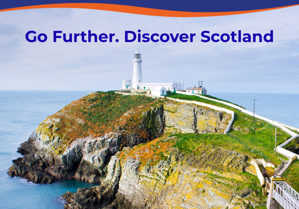 A lighthouse on a rocky cliff overlooking the sea, surrounded by green grass and pathways.