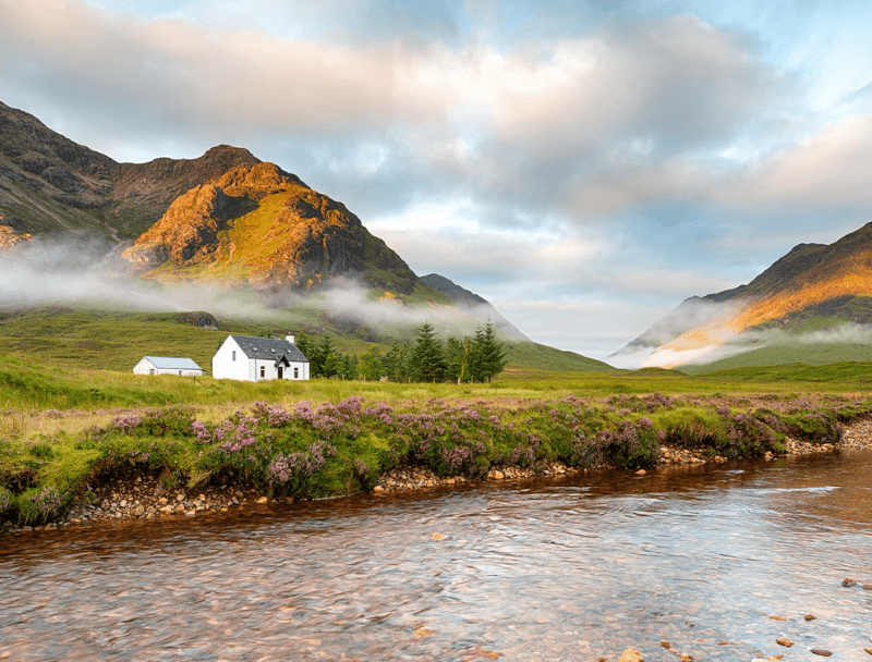 A serene landscape featuring a white house by a river, surrounded by mountains and heather.