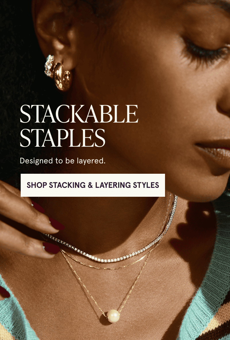 A model wearing gold, diamond and pearl jewelry. Designed to be layered. Click here to shop stacking and layering styles