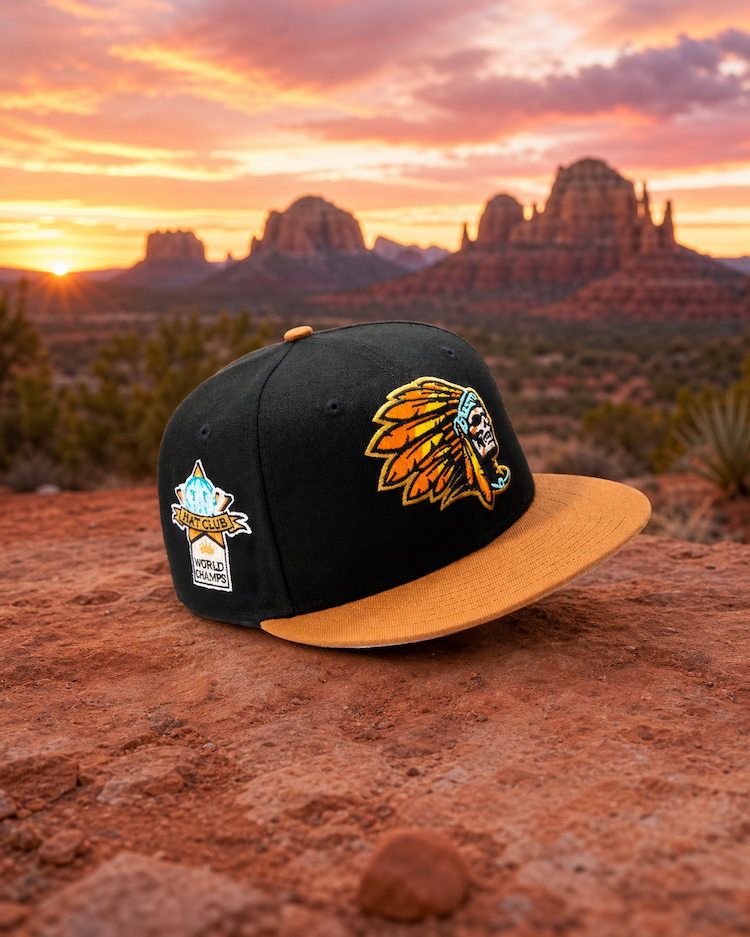 Black baseball cap with a Native American-inspired skull logo and a tan brim.
