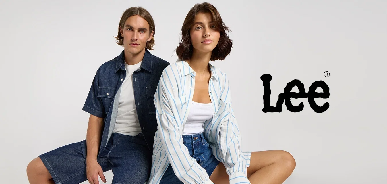 Zwei Models posieren: ein Mann in einem dunklen Denim-Hemd und Shorts sowie eine Frau in einem gestreiften blauen Hemd und Jeans-Shorts, beide in lässigem Stil.