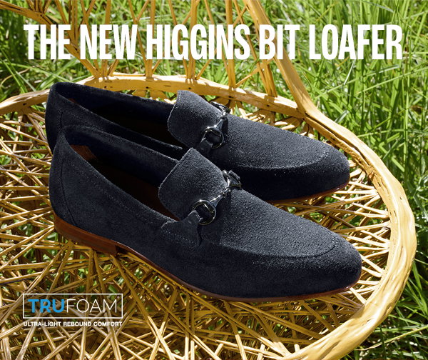 Navy suede Higgins Bit Loafers with metal bit hardware displayed on a woven chair outdoors. Text reads: 