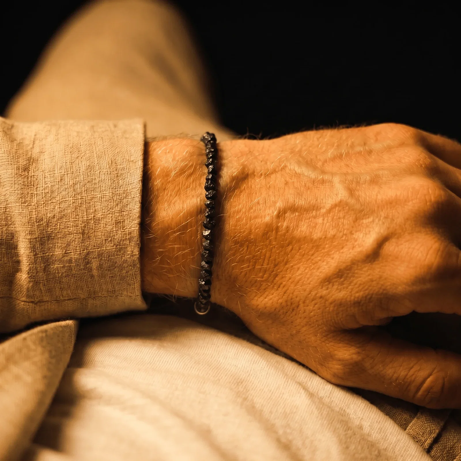 Raw Black Diamond Bracelet 25 carats on the wrist in sunlight
