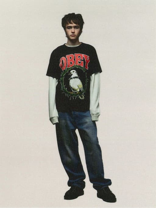 Model wearing obey shirt with graphic of a dove