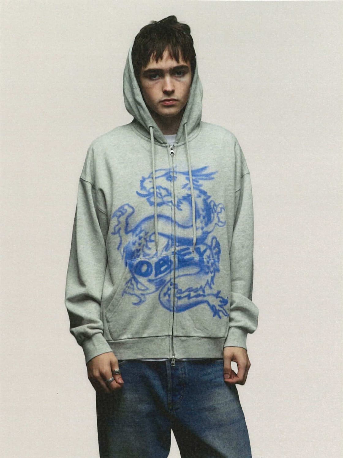 Male model  wearing Obey hoodie with blue dragon 