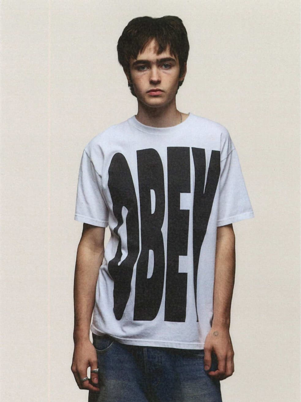 Model wewaring white t shirt with OBEY written on it 