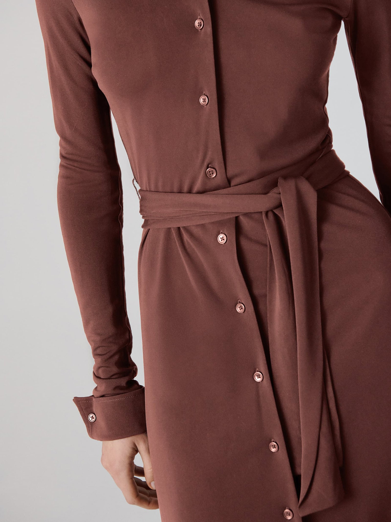 Model wearing a long-sleeve shirt dress.
