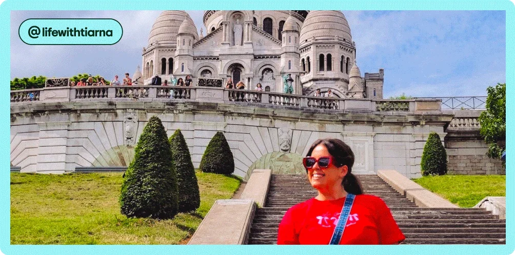 Image description: A woman standing on the steps in front of the Basilique Du Sacre-Coeur De Montmartre in Paris, photo taken by @lifewithtiarna