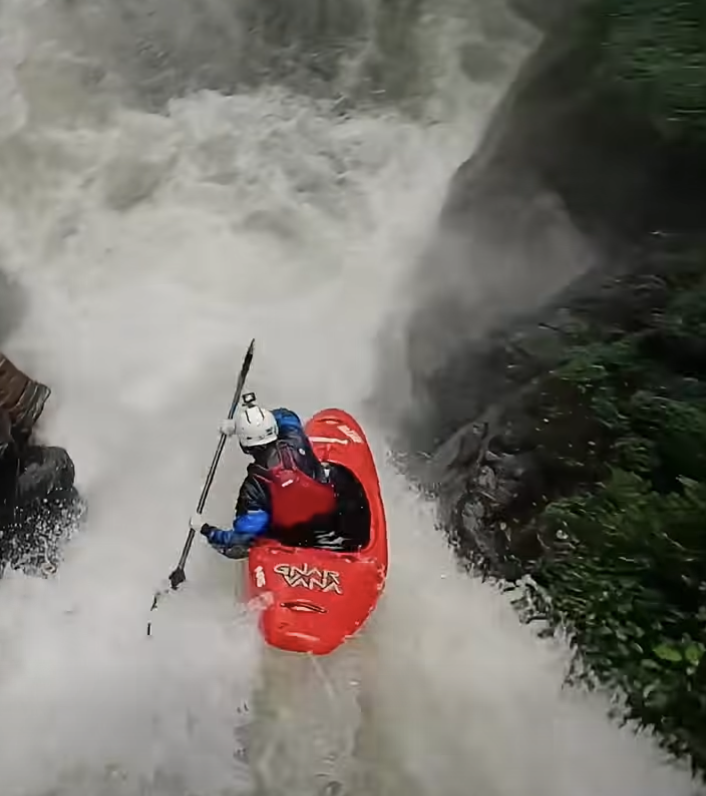 Kayaker dropping waterfall