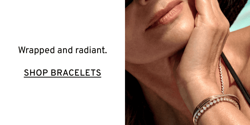 Model wearing gold & diamond bracelets on a wrist. Wrapped and radiant. Click to Shop Bracelets