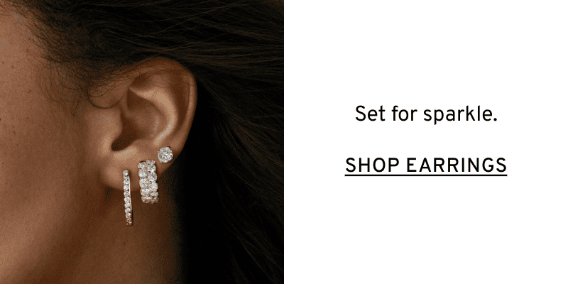 Close-up of three diamond earrings in ear. Set for sparkle. Click to Shop Earrings