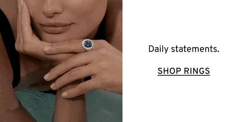 Blue ring on a model’s hand. Daily statements. Click to Shop Rings