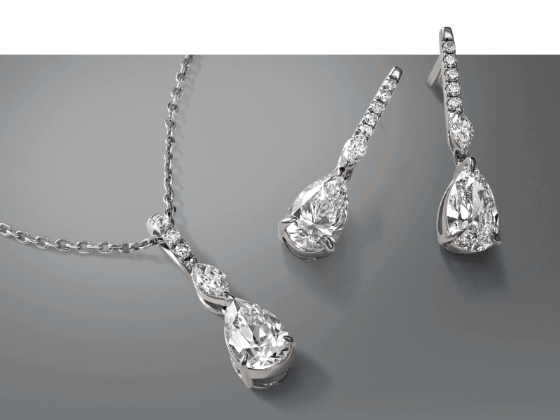 White gold necklace and matching drop earrings with pear-shaped stones.