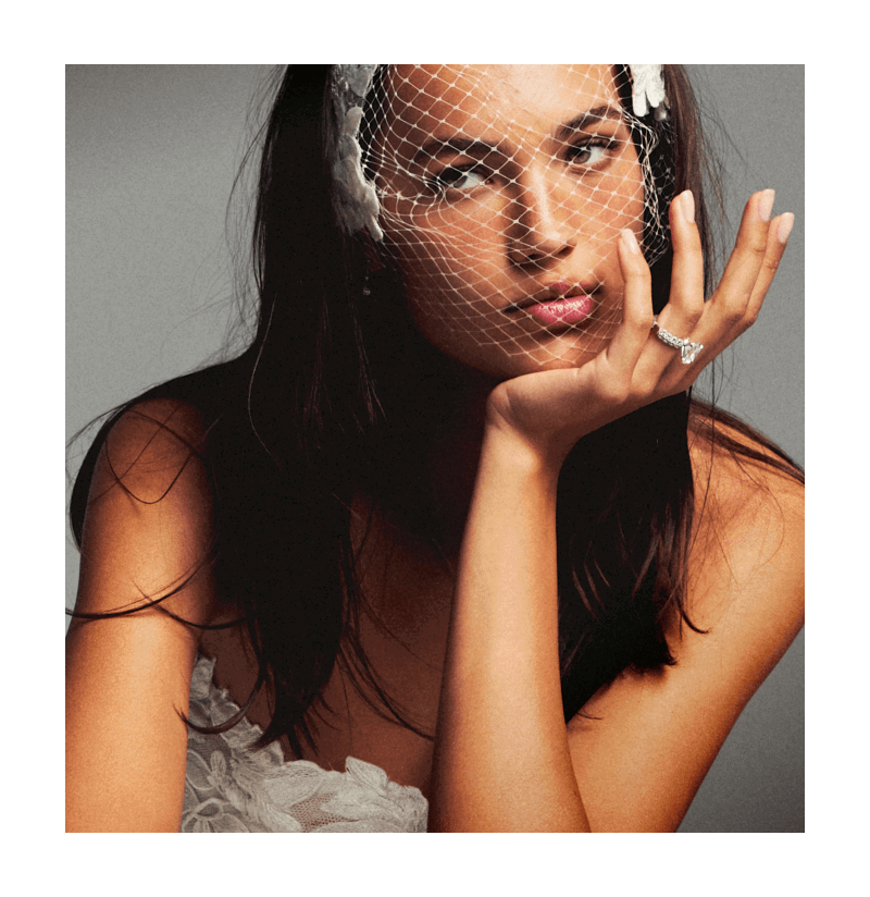 Bride wearing a veil and a diamond engagement ring.