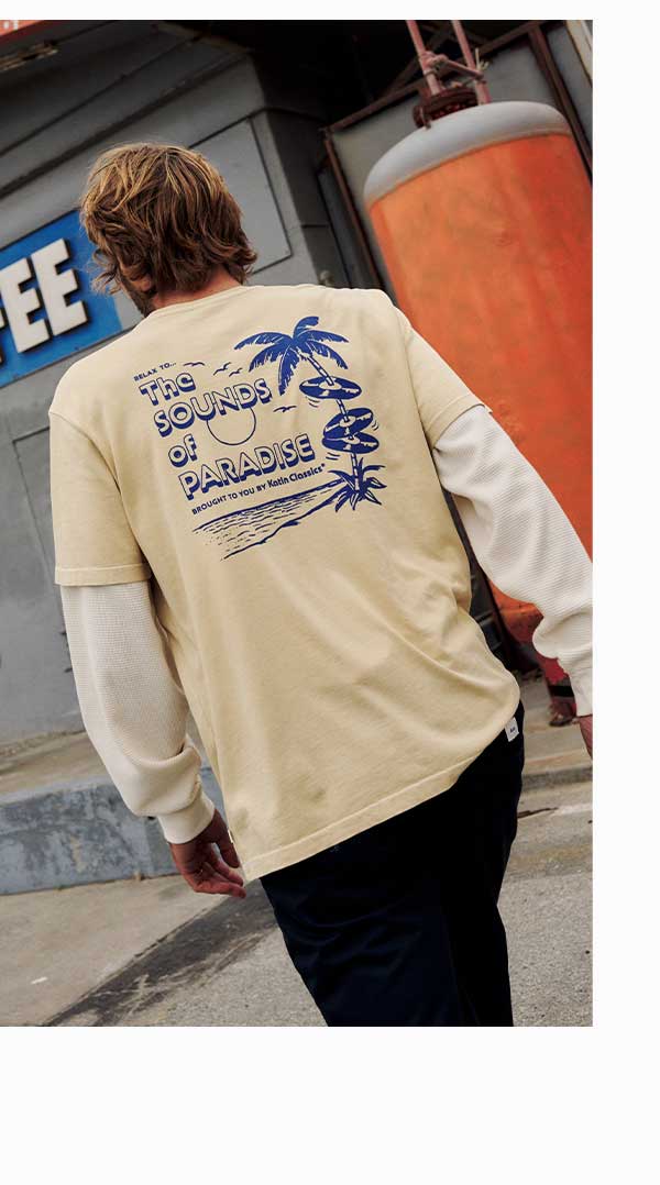 Male model walking by gas station wearing Sonics Tee.