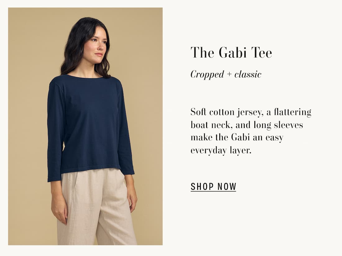 Image of model wearing Gabi in Navy. Text reads: The Gabi Tee. Cropped + classic. Soft cotton jersey, a flattering boat neck, and long sleeves make the Gabi an easy everyday layer.